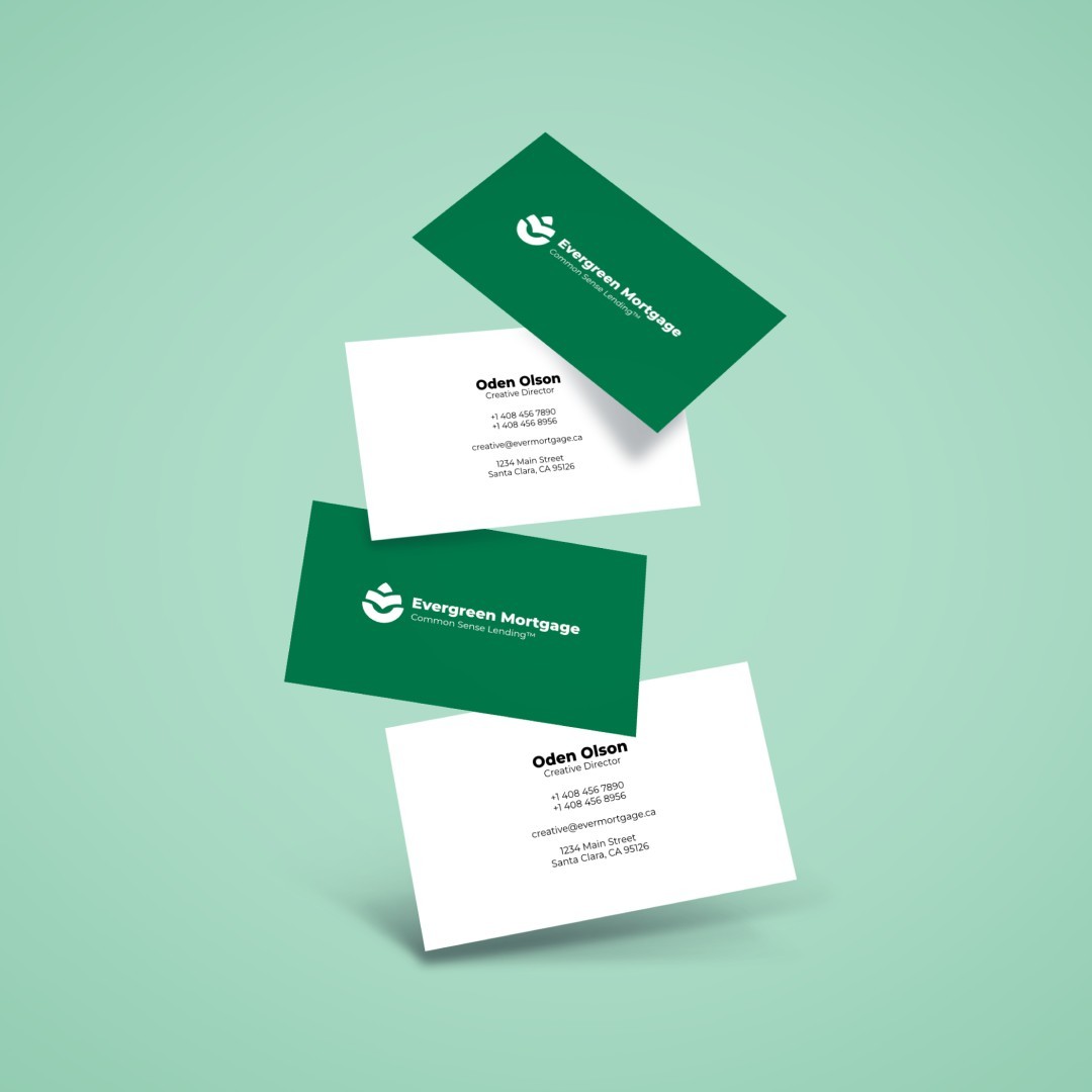 Business cards floating in front of a pale green wall.