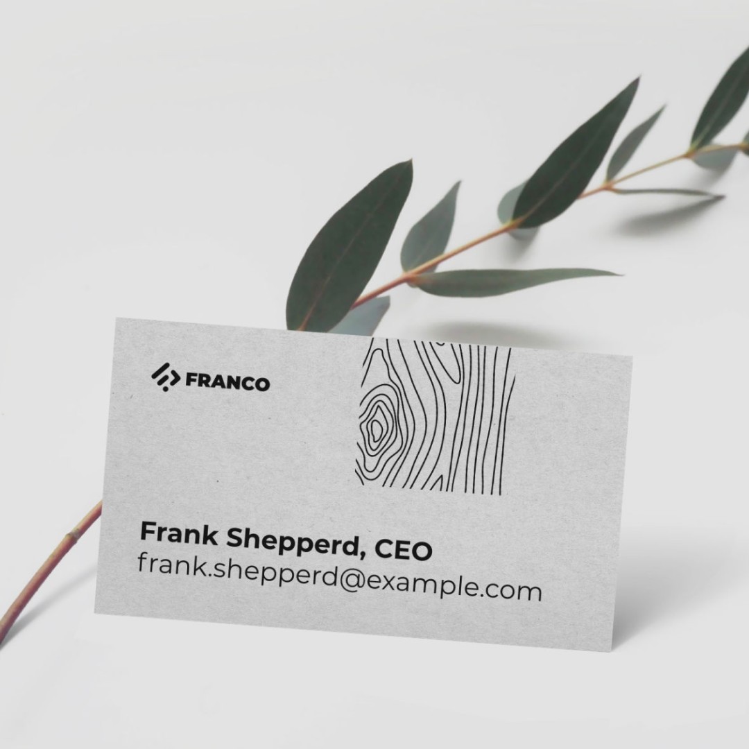 A gray business card with the logo, the name and the email. There is a small area on the edge filled with lines that look like wavy shades on concrete being poured into the mould.