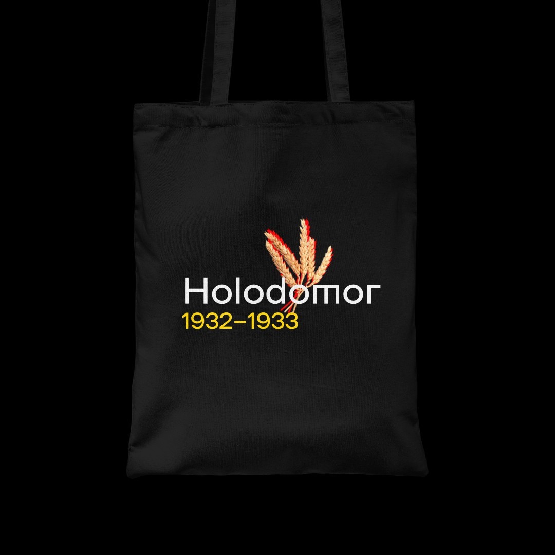 A black tote bag with the words Holodomor 1932–1933 and three wheat spikelets symbolizing the famine.