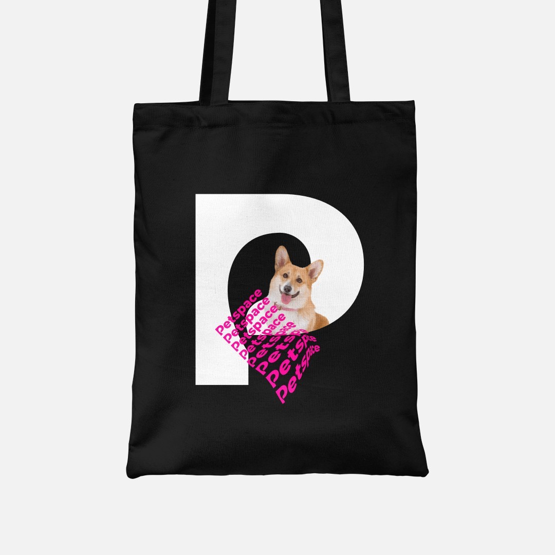 A black tote bag with the letter P taking almost all of the space. There is a dog inside the letter. Several lines with the word Petspace in pink are deformed and floating beside the dog.